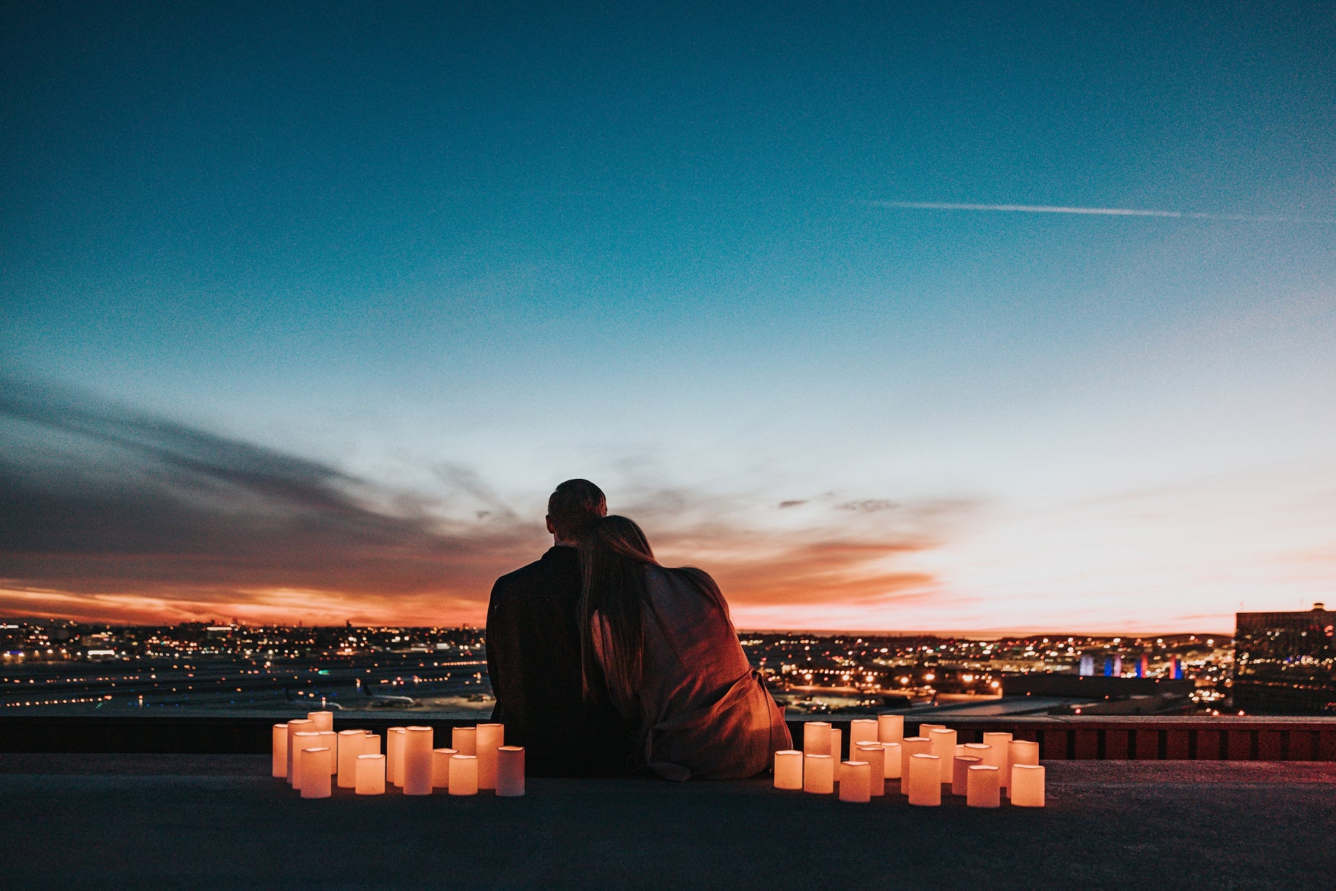 Romantic couple looking at the sunsent